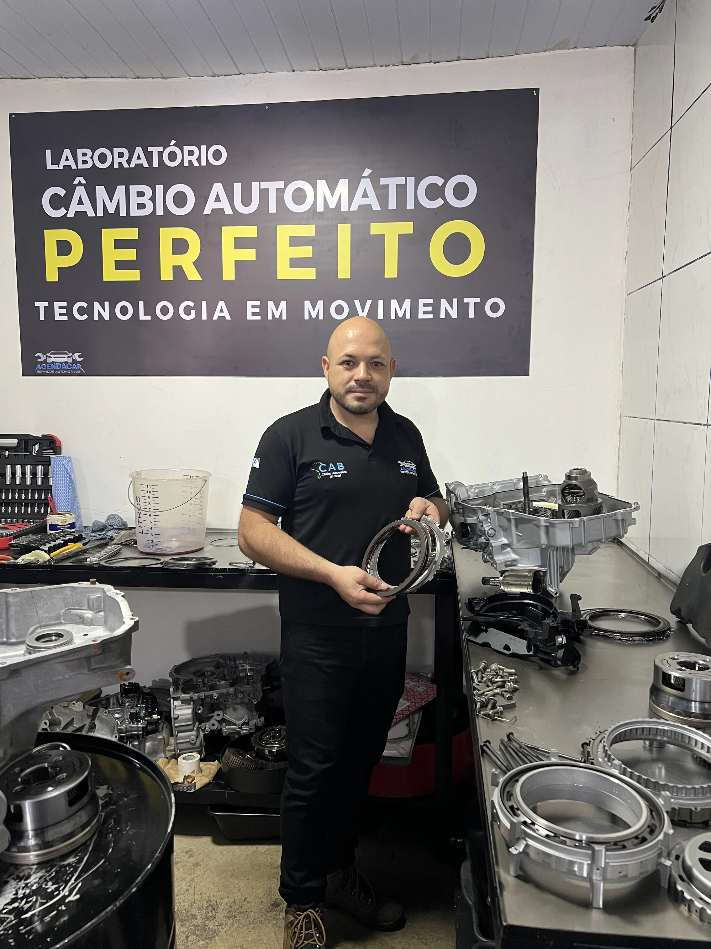 Técnico da AgendaCar com componente de câmbio automático no Laboratório